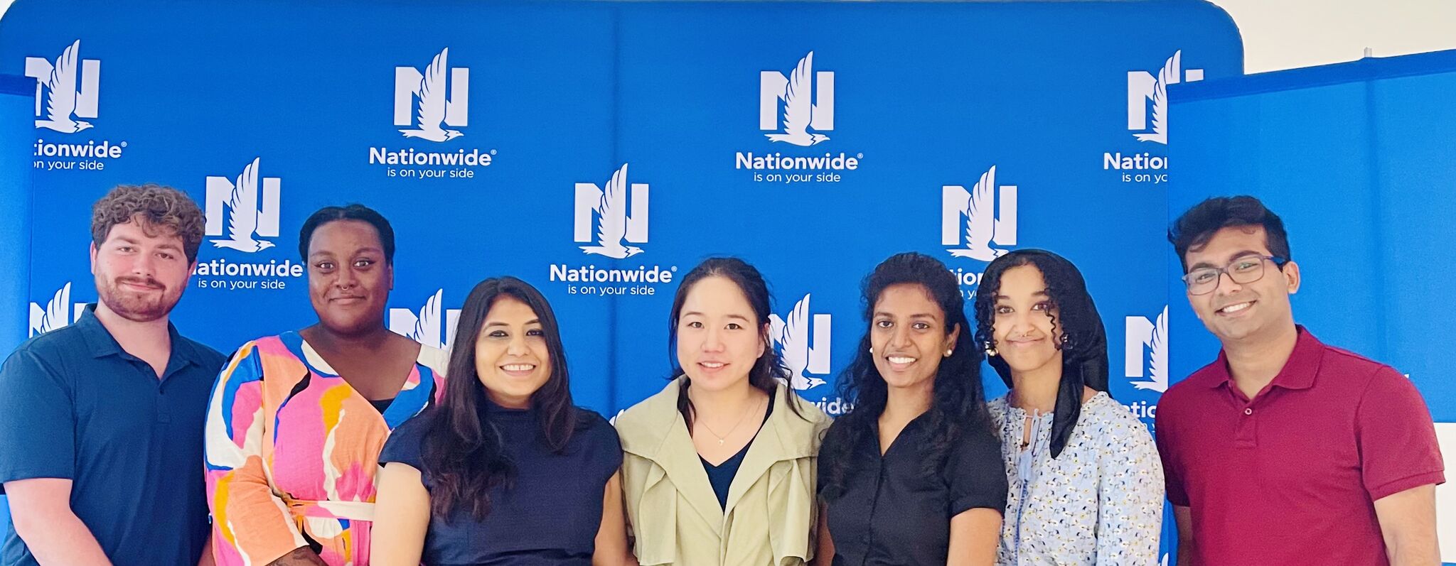 The 2023 Nationwide OSCD intern cohort standing together in front of a Nationwide backdrop